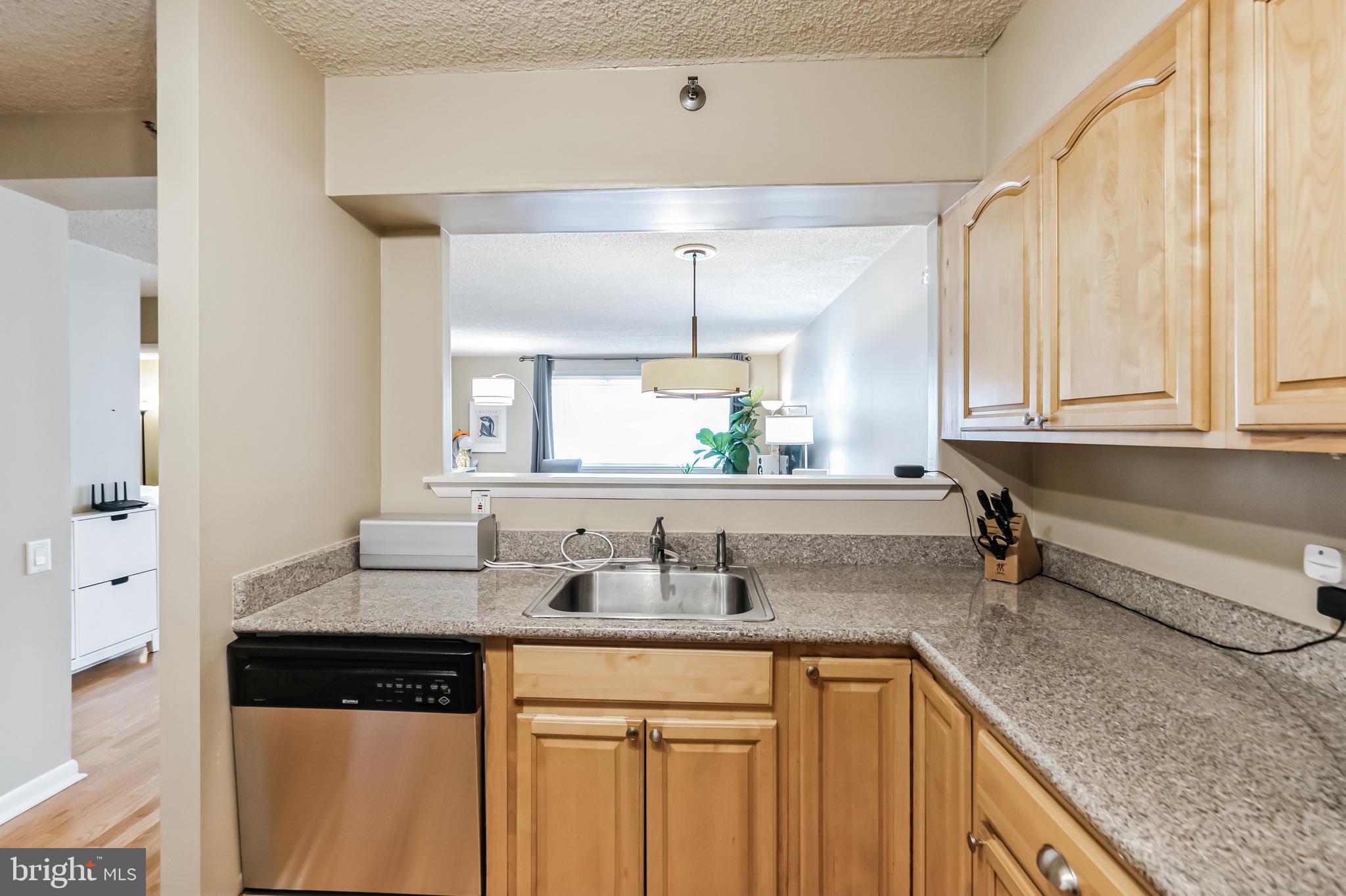 2201 Cherry Street, Unit 603 Philadelphia, PA 19103 - Photo 21 of 32 a kitchen with stainless steel appliances granite countertop a sink and cabinets