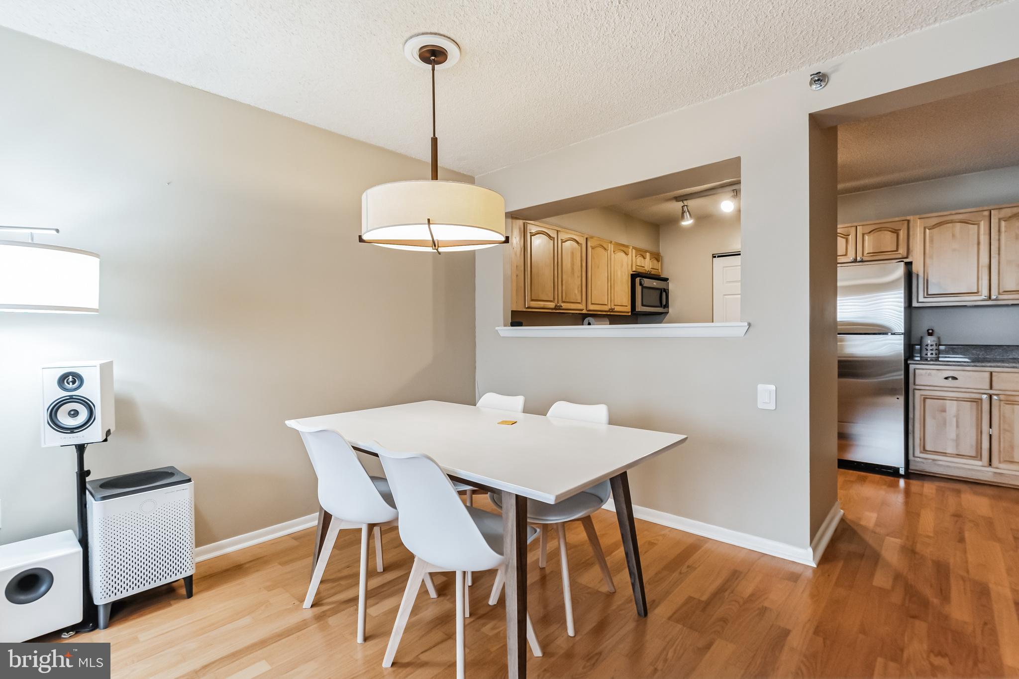 2201 Cherry Street, Unit 603 Philadelphia, PA 19103 - Photo 23 of 32 a view of a dining room with furniture wooden floor and chandelier