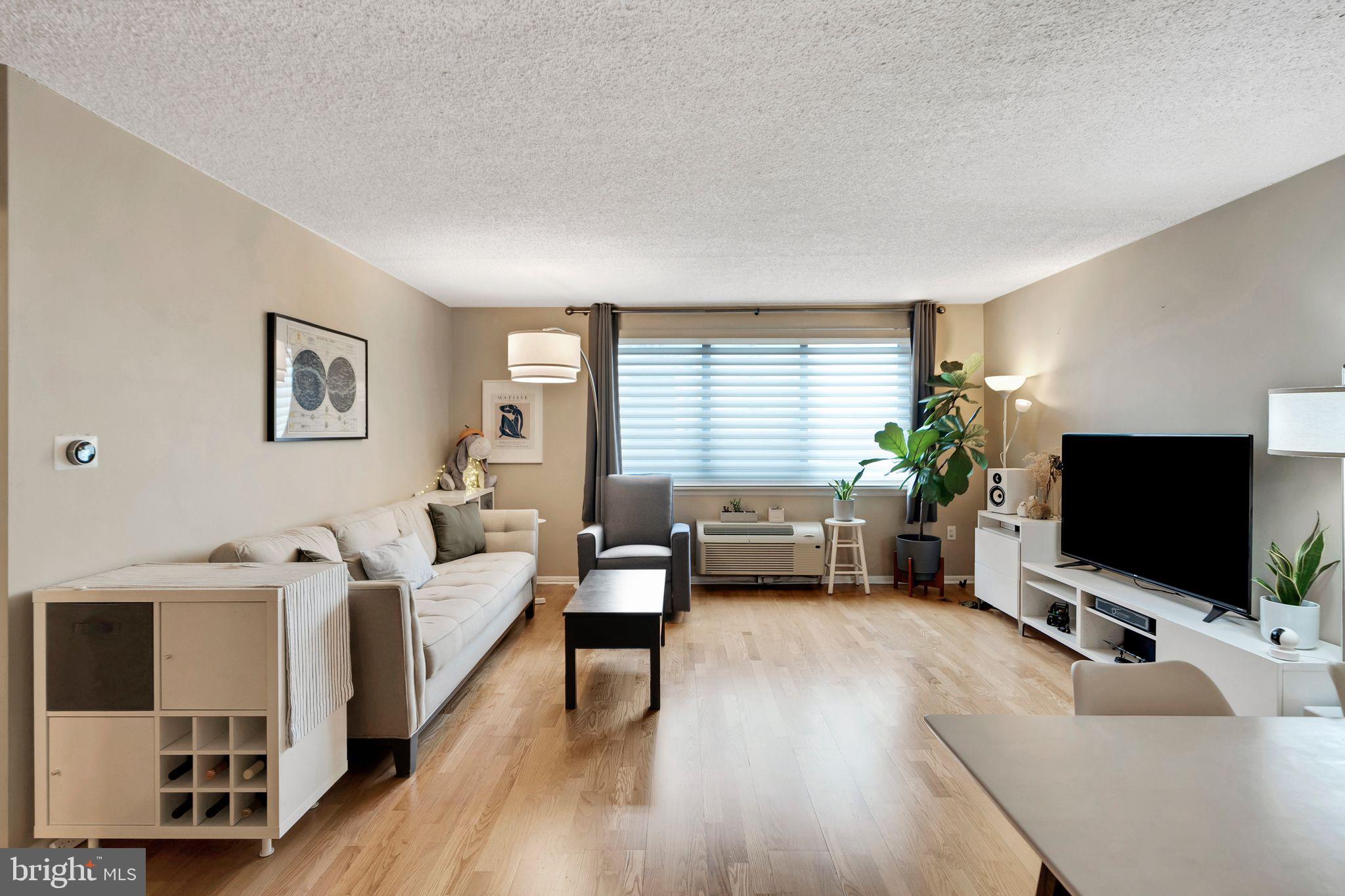 2201 Cherry Street, Unit 603 Philadelphia, PA 19103 - Photo 8 of 32 a living room with furniture and a flat screen tv