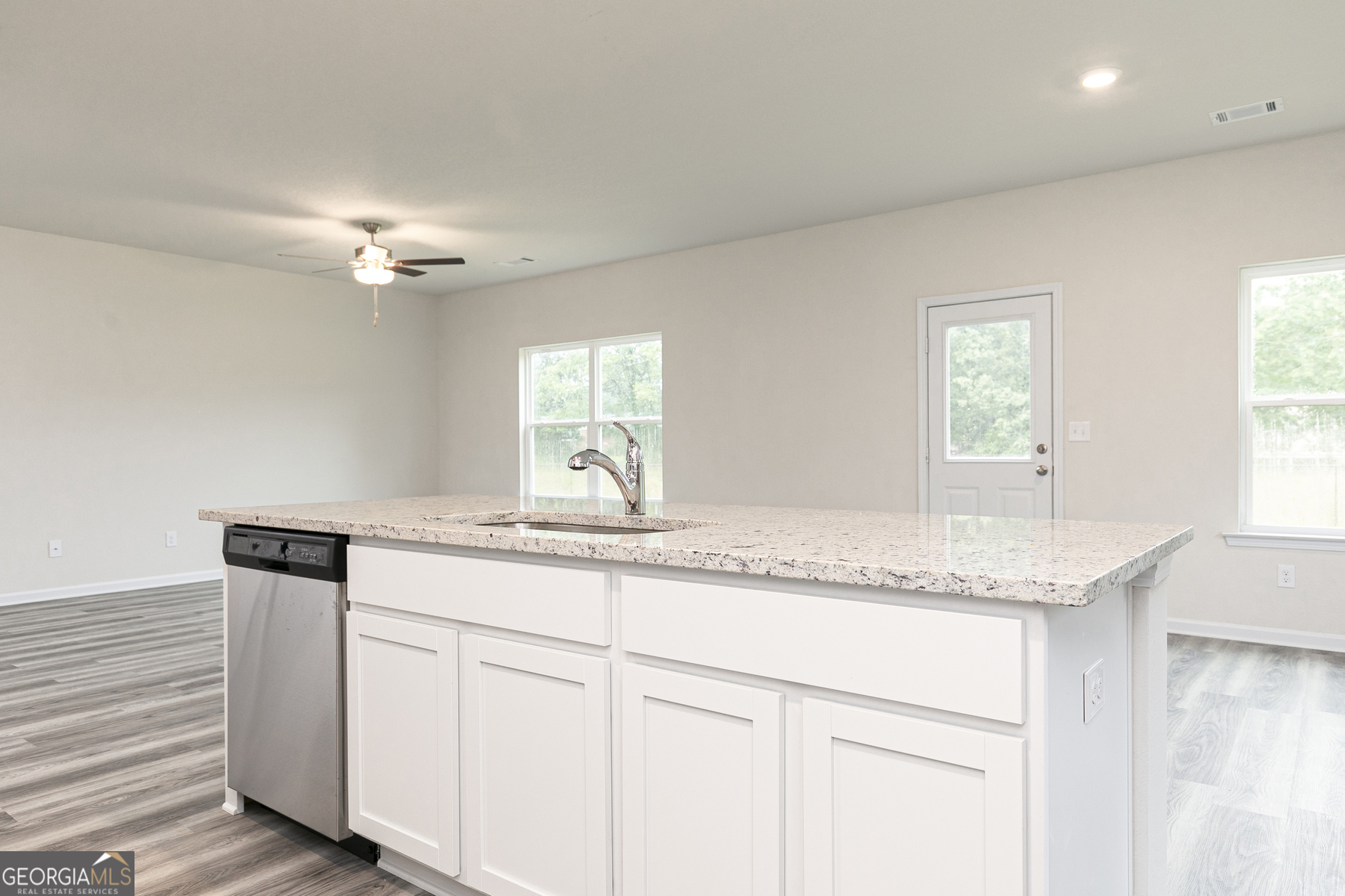 620 Slate Road Conyers, GA 30013 - Photo 12 of 22 a kitchen with granite countertop cabinets stainless steel appliances a sink and a window