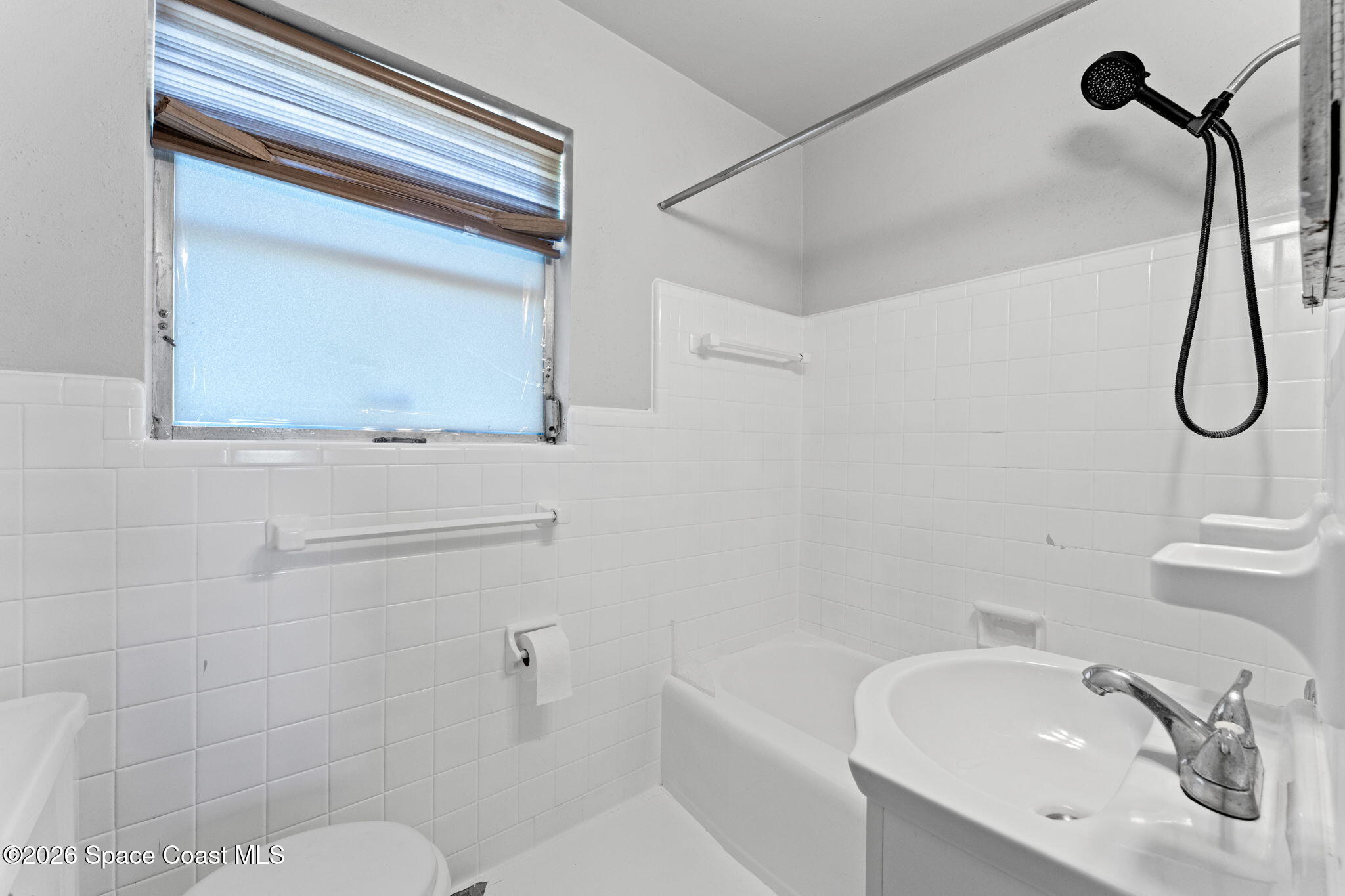 1042 Azalea Lane Cocoa, FL 32922 - Photo 15 of 26 a bathroom with a sink a toilet and shower