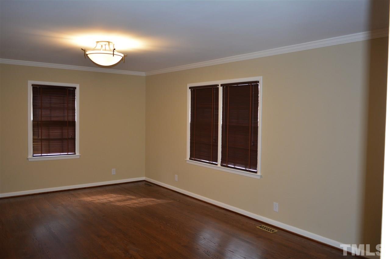 2604 Patrick Road Raleigh, NC 27604 - Photo 2 of 9 an empty room with wooden floor and windows