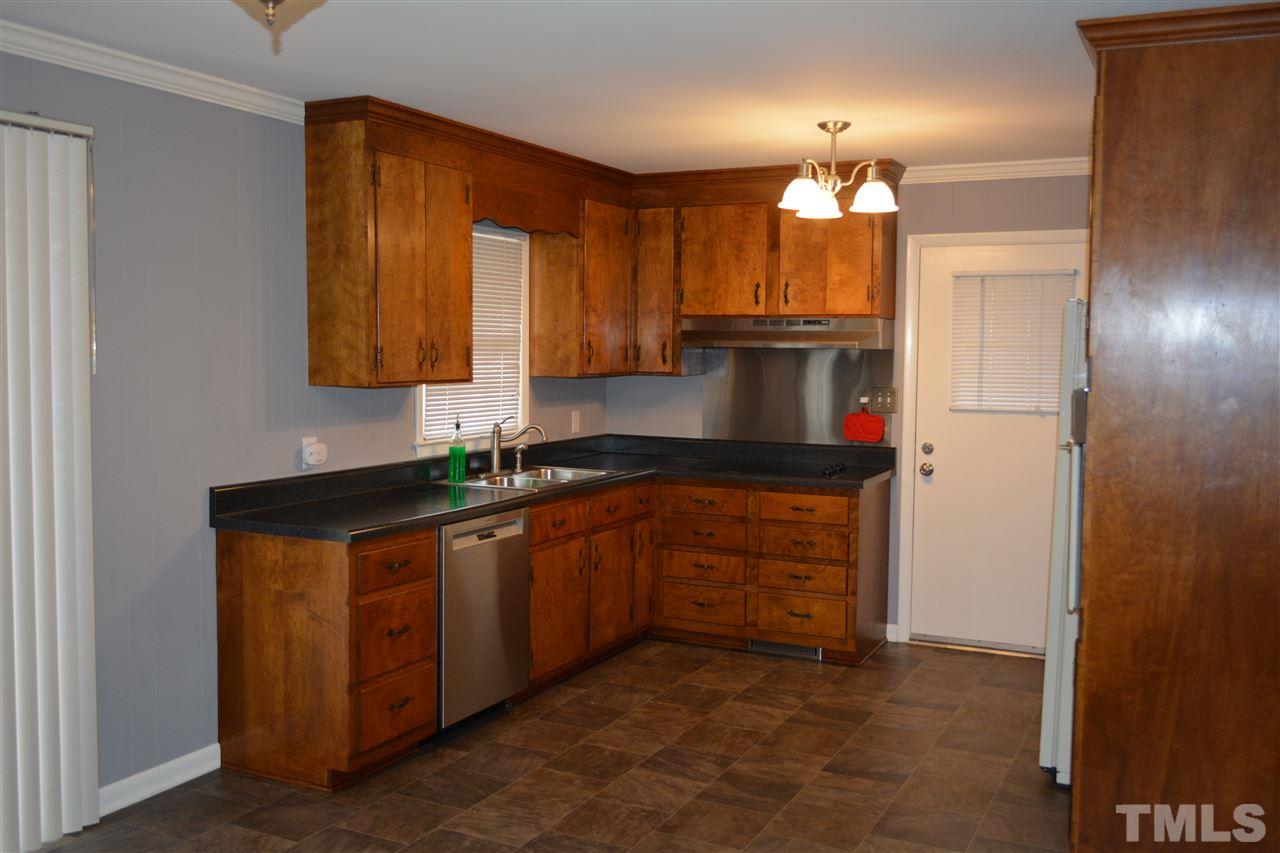 2604 Patrick Road Raleigh, NC 27604 - Photo 3 of 9 a kitchen with stainless steel appliances granite countertop a stove a sink and a refrigerator