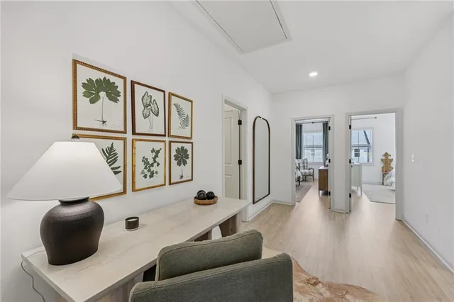 a room with stainless steel appliances kitchen island granite countertop furniture and a chandelier