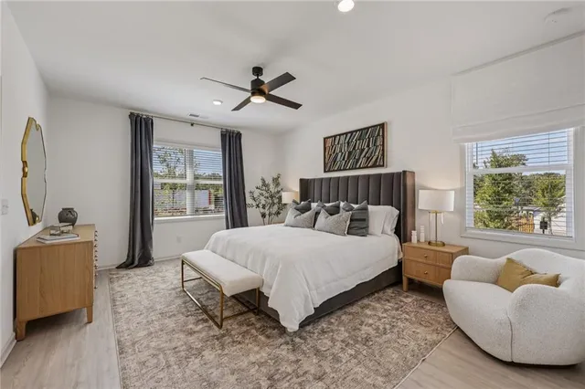 a dining hall with a black white checkered floor with couches chair and a coffee table