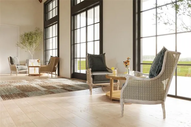 a kitchen with stainless steel appliances granite countertop a dining table chairs refrigerator and microwave