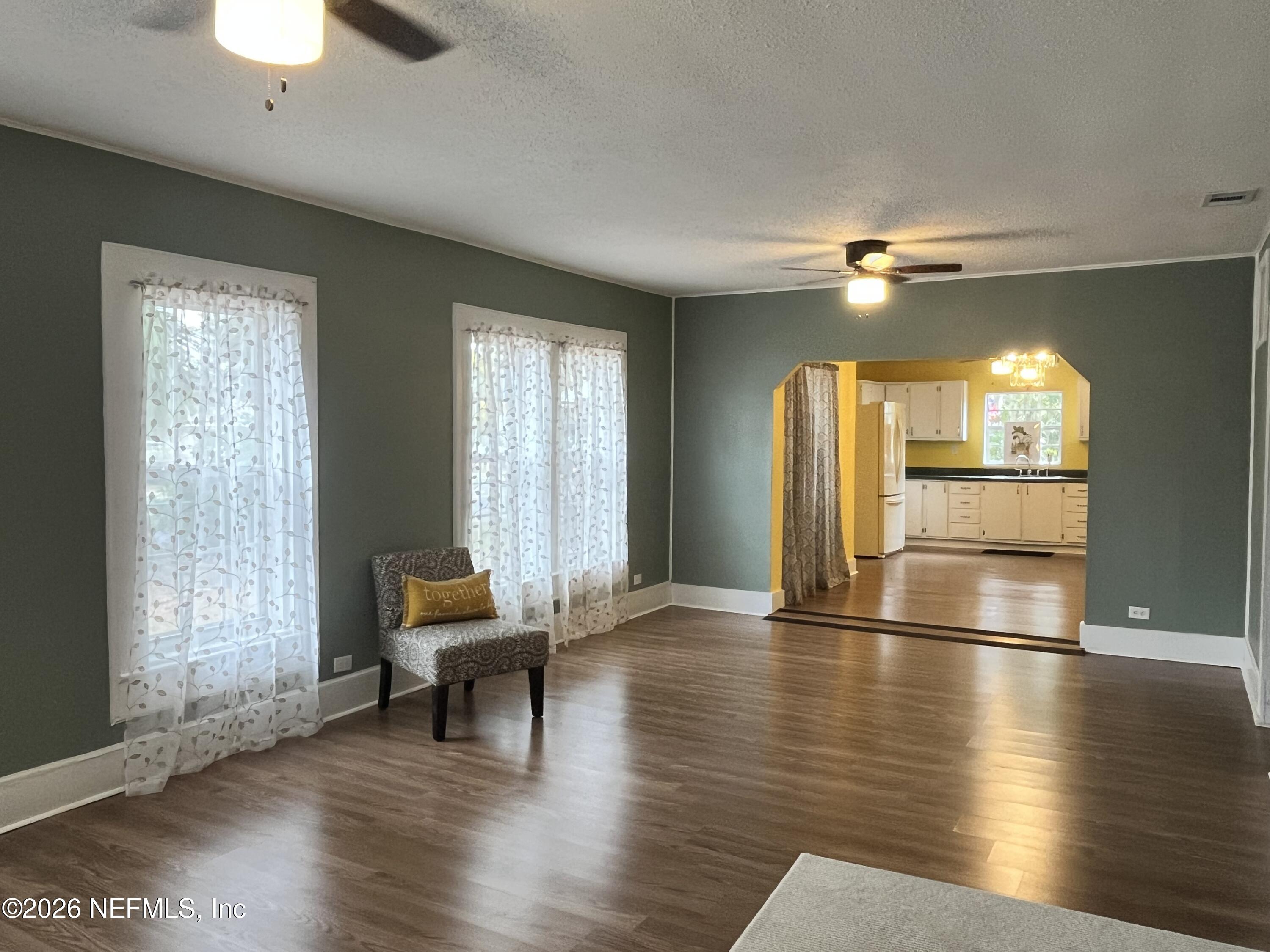 624 North Lake Street Starke, FL 32091 - Photo 16 of 34 a view of a livingroom with wooden floor and a ceiling fan