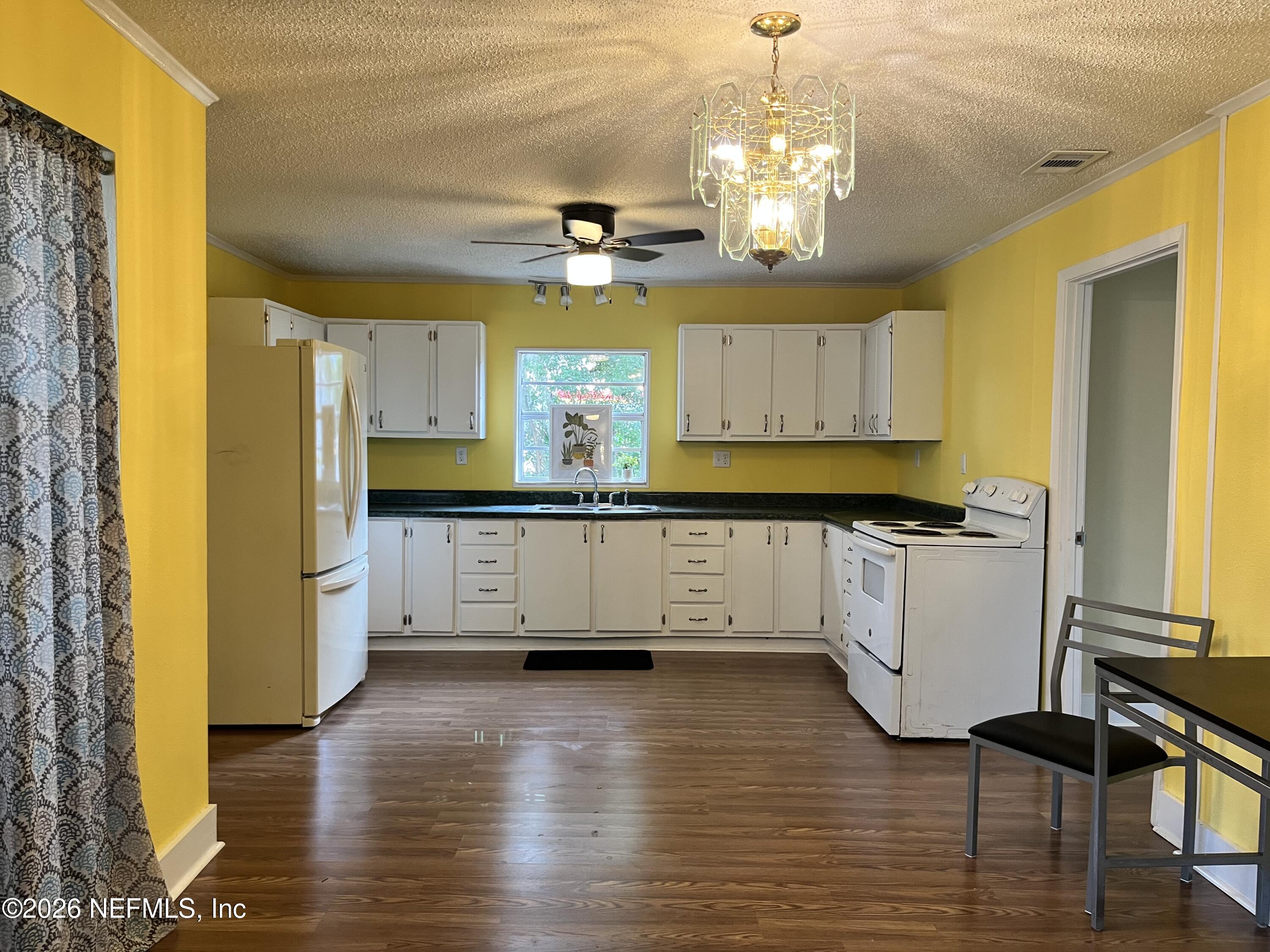 624 North Lake Street Starke, FL 32091 - Photo 21 of 34 a view of kitchen with granite countertop cabinets and wooden floor