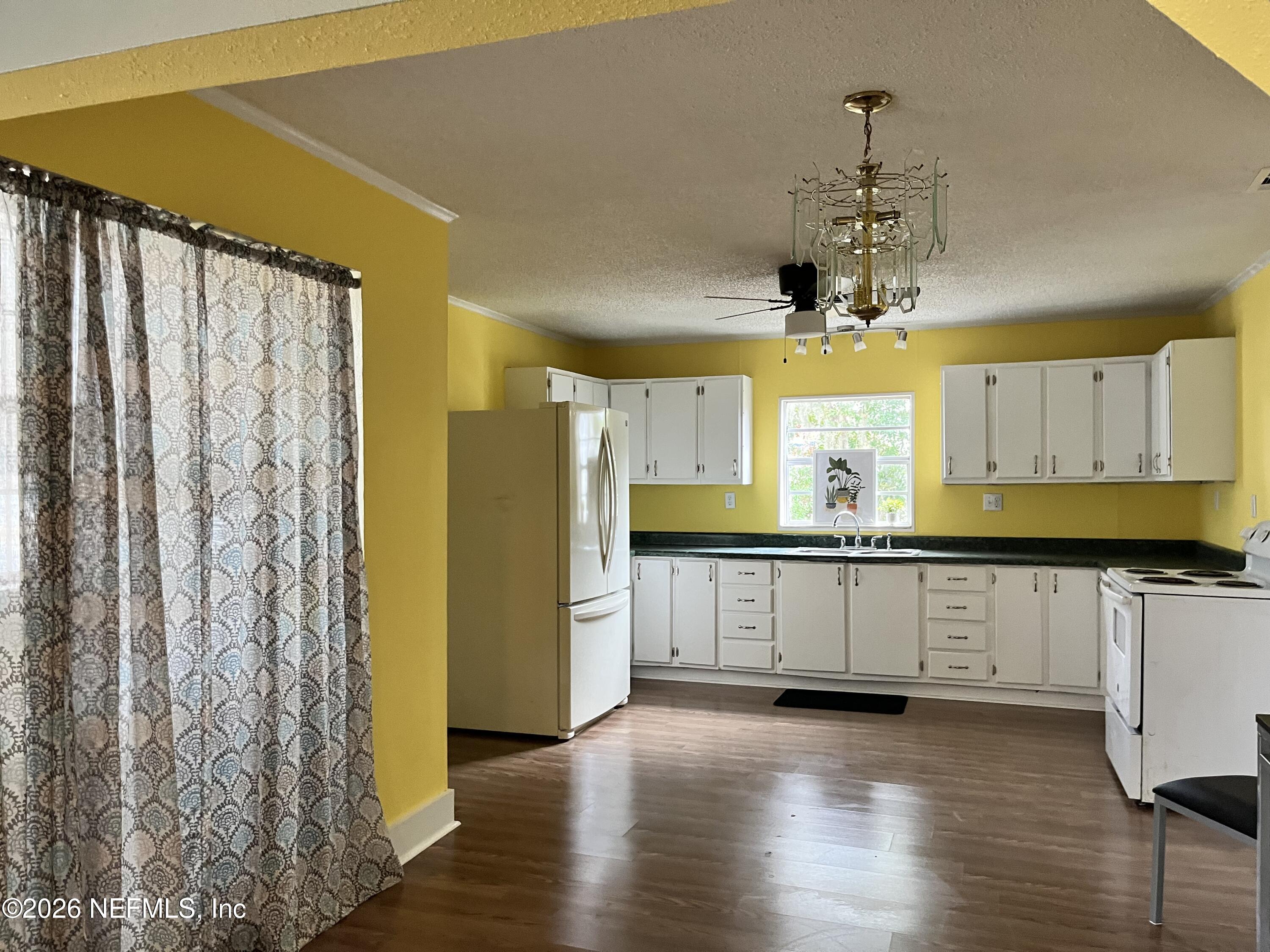 624 North Lake Street Starke, FL 32091 - Photo 23 of 34 a kitchen with stainless steel appliances a refrigerator and a stove top oven