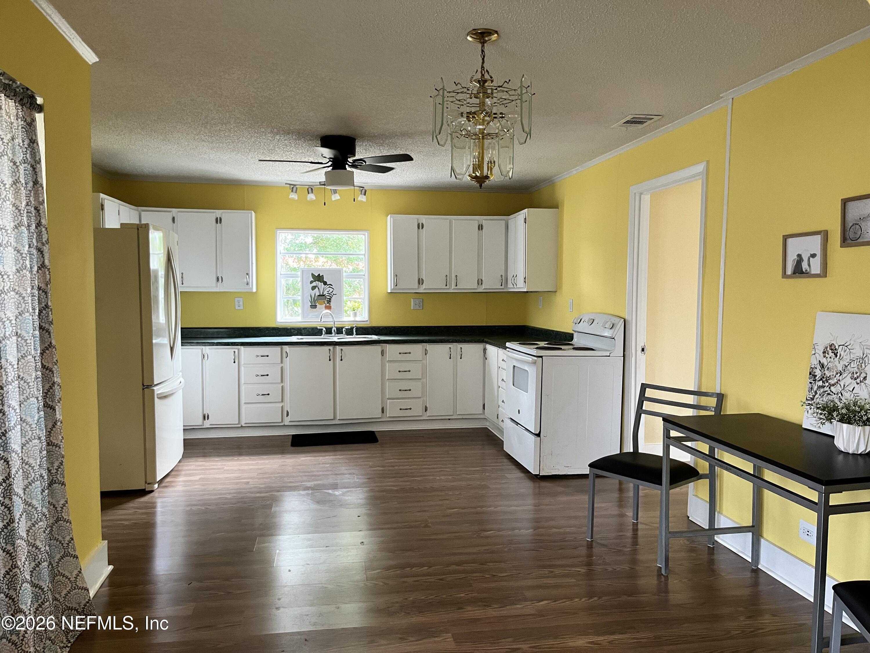 624 North Lake Street Starke, FL 32091 - Photo 25 of 34 a view of a kitchen with furniture and wooden floor