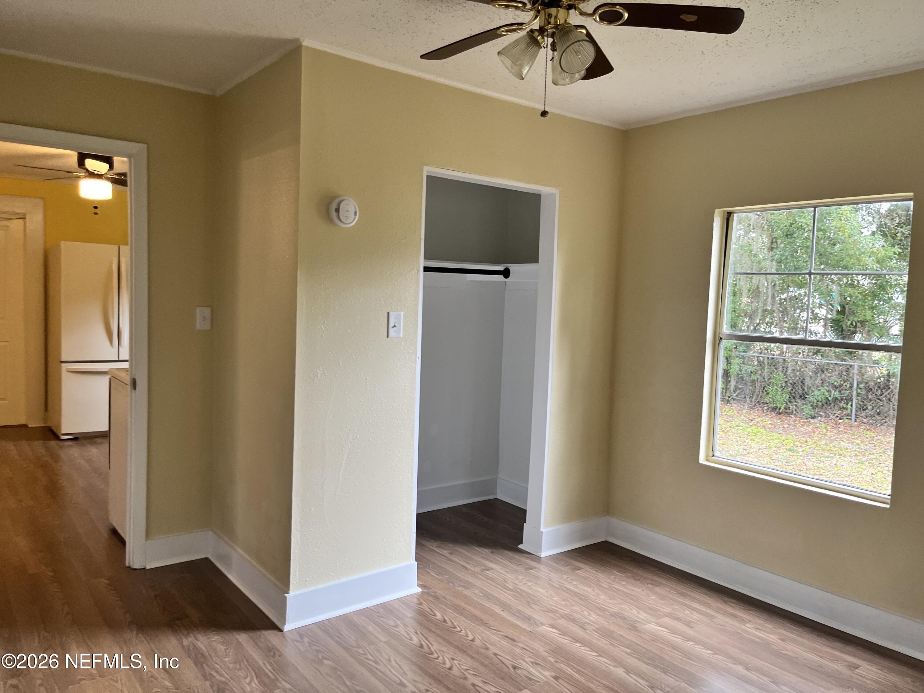 624 North Lake Street Starke, FL 32091 - Photo 30 of 34 a view of an empty room with a window and wooden floor