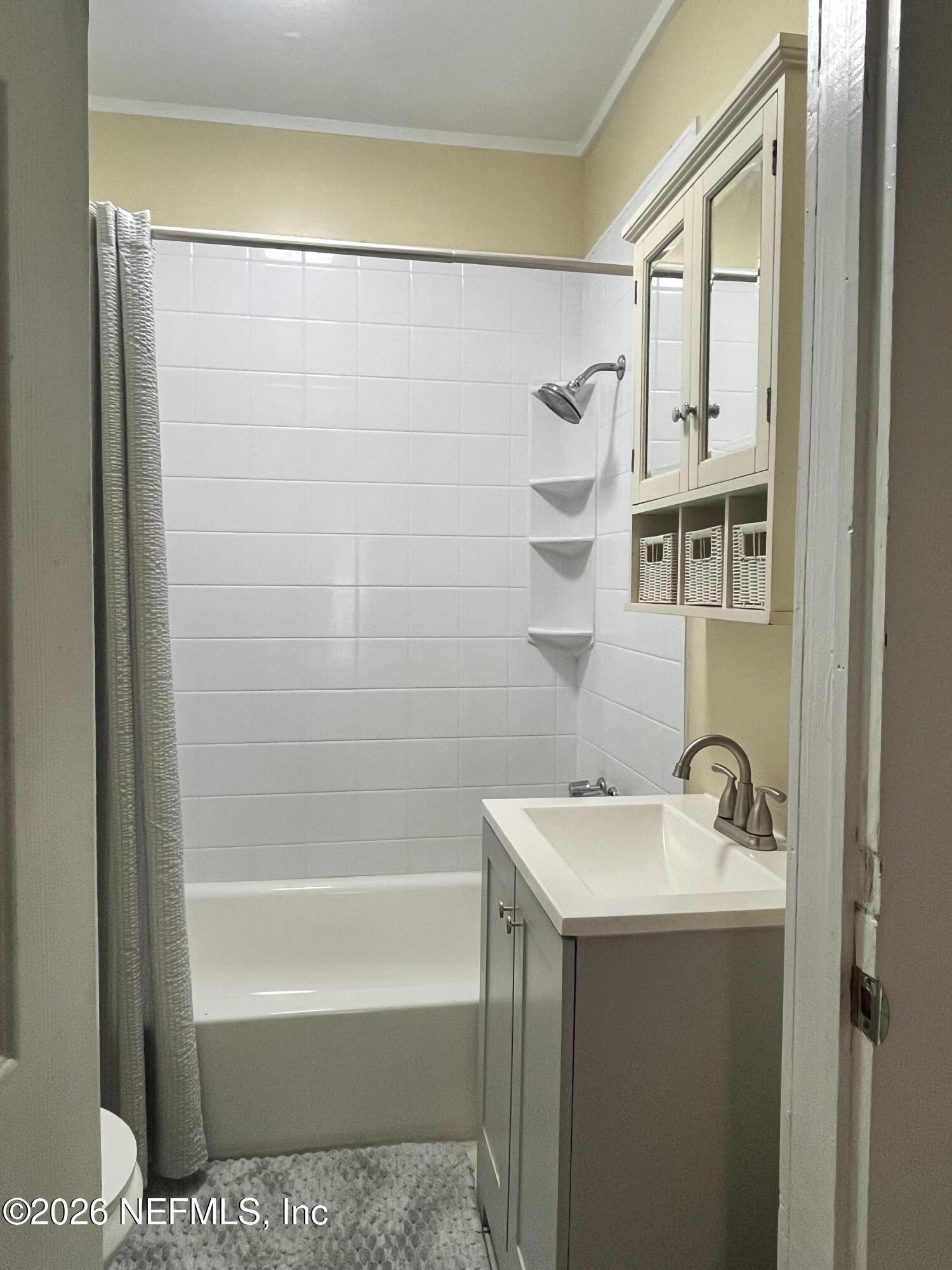 624 North Lake Street Starke, FL 32091 - Photo 33 of 34 a bathroom with a shower a sink and a mirror