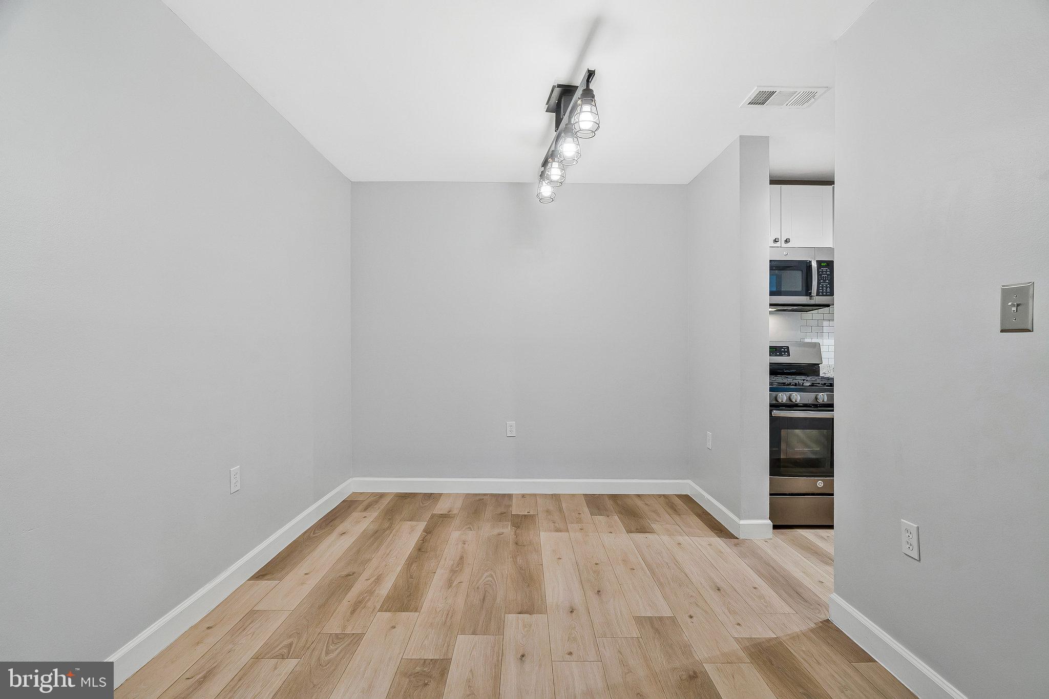 20991 Timber Ridge Terrace, Unit 103 Ashburn, VA 20147 - Photo 12 of 58 a view of a hallway with wooden floor and entryway
