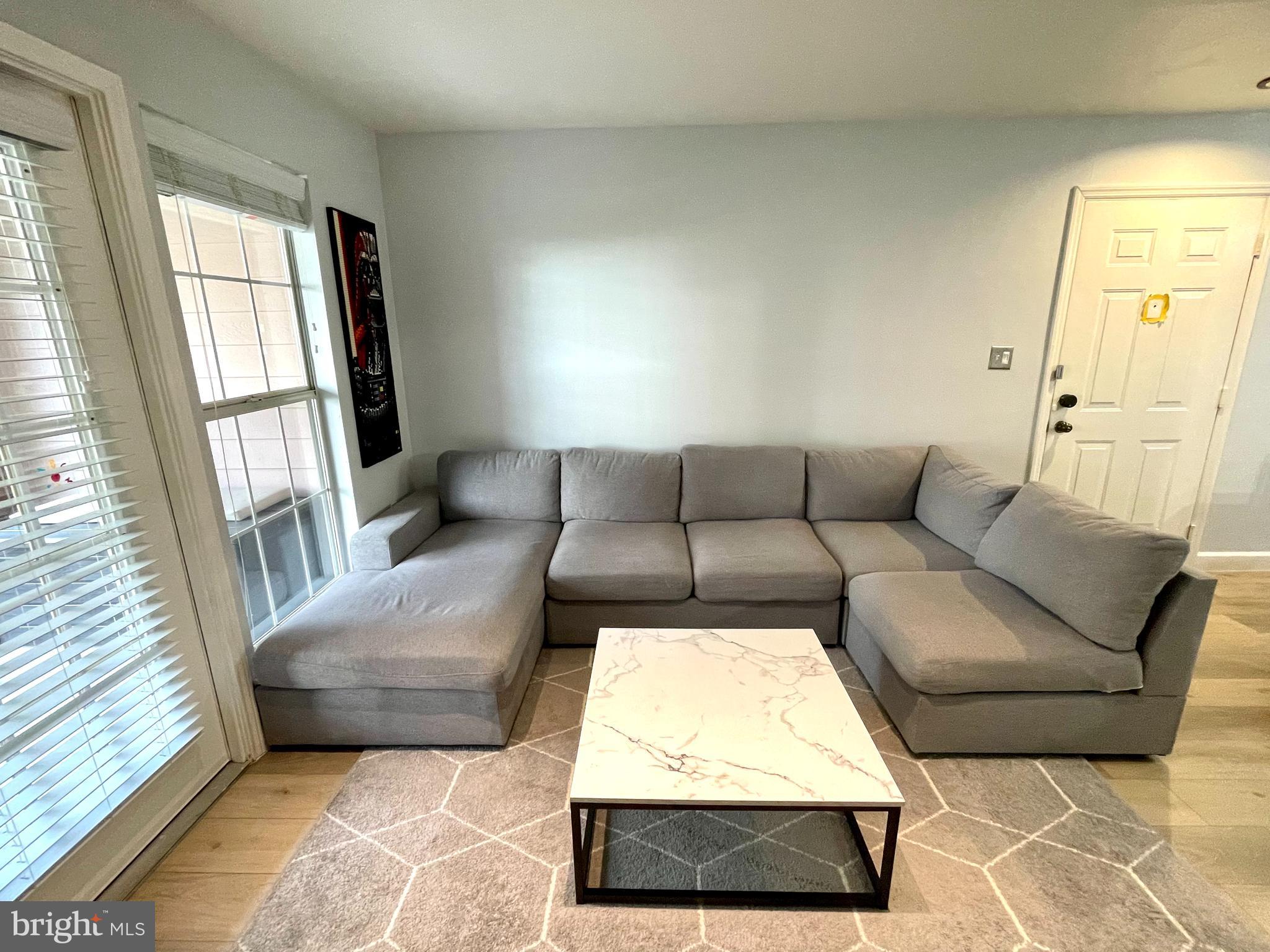 20991 Timber Ridge Terrace, Unit 103 Ashburn, VA 20147 - Photo 17 of 58 a living room with furniture and a window