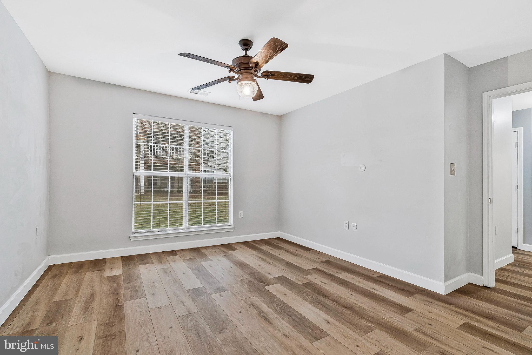 20991 Timber Ridge Terrace, Unit 103 Ashburn, VA 20147 - Photo 19 of 58 a view of empty room with wooden floor and fan