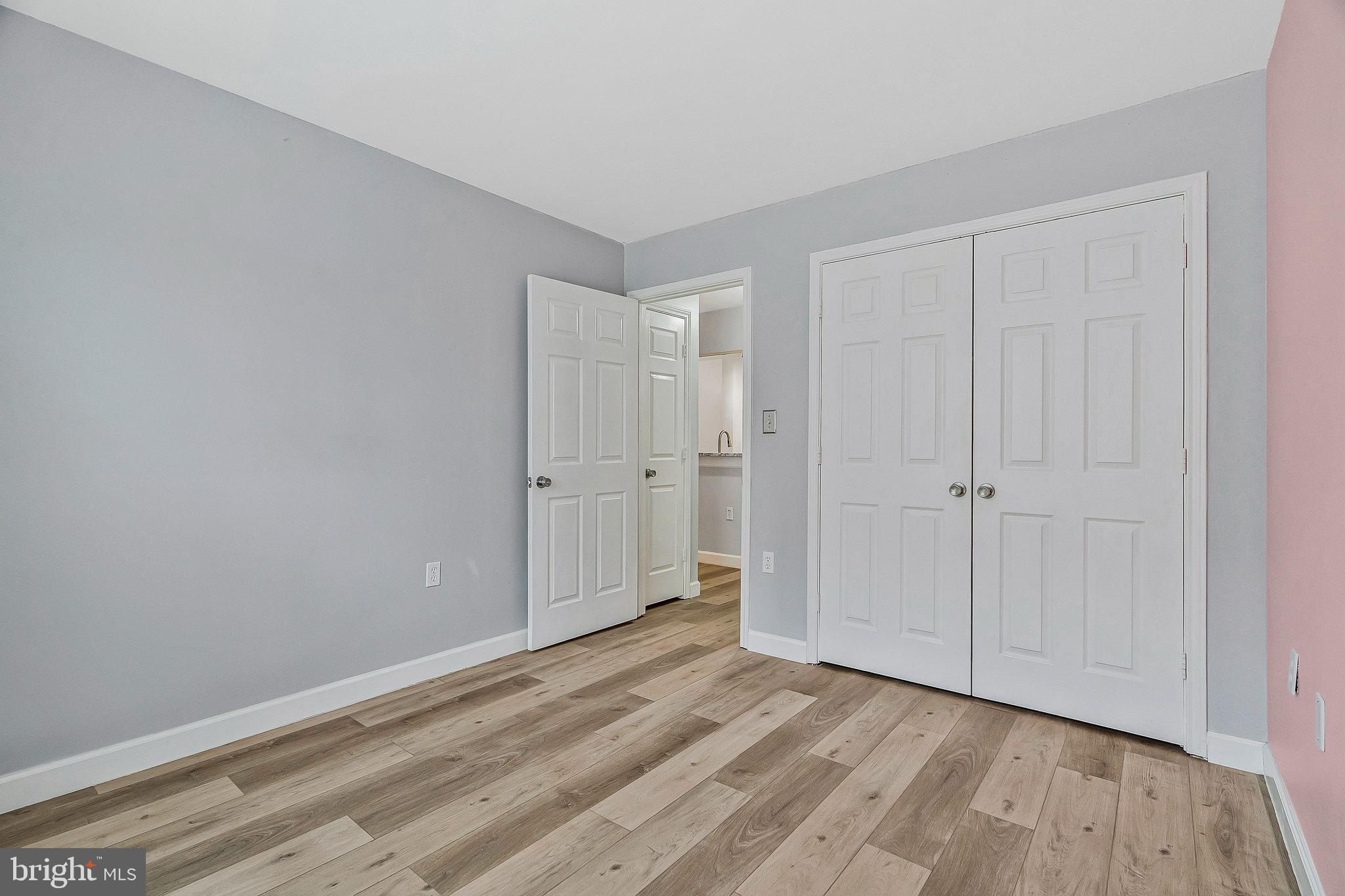 20991 Timber Ridge Terrace, Unit 103 Ashburn, VA 20147 - Photo 25 of 58 a view of an empty room and wooden floor