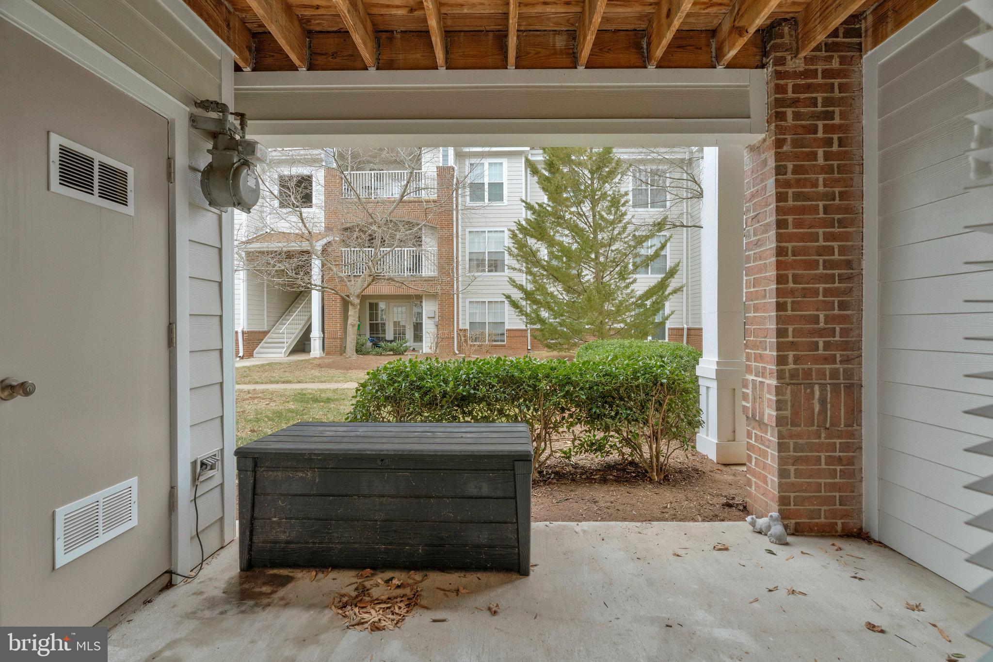 20991 Timber Ridge Terrace, Unit 103 Ashburn, VA 20147 - Photo 29 of 58 a front view of a house with a yard