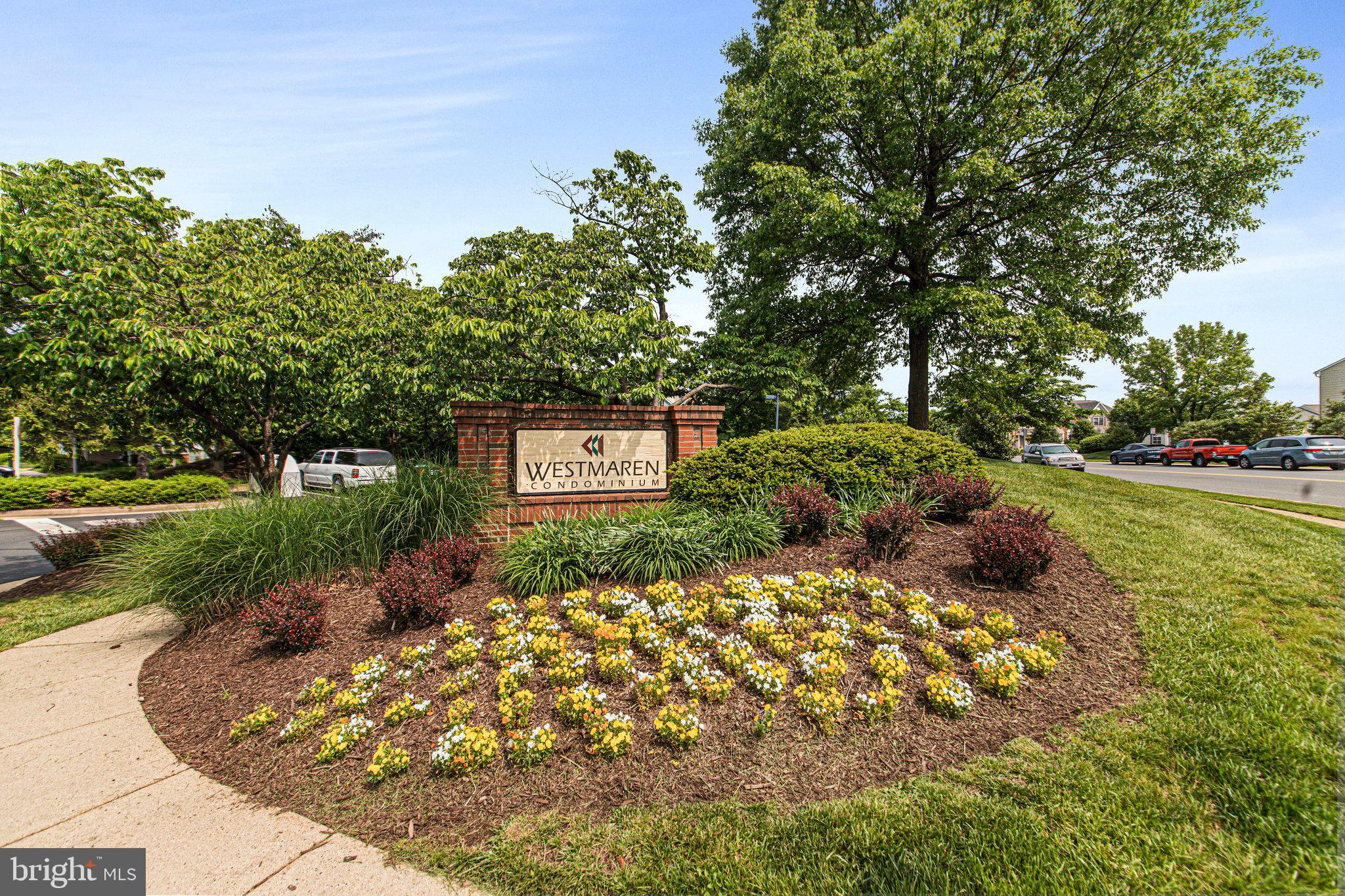 20991 Timber Ridge Terrace, Unit 103 Ashburn, VA 20147 - Photo 37 of 58 a front view of a house with a yard