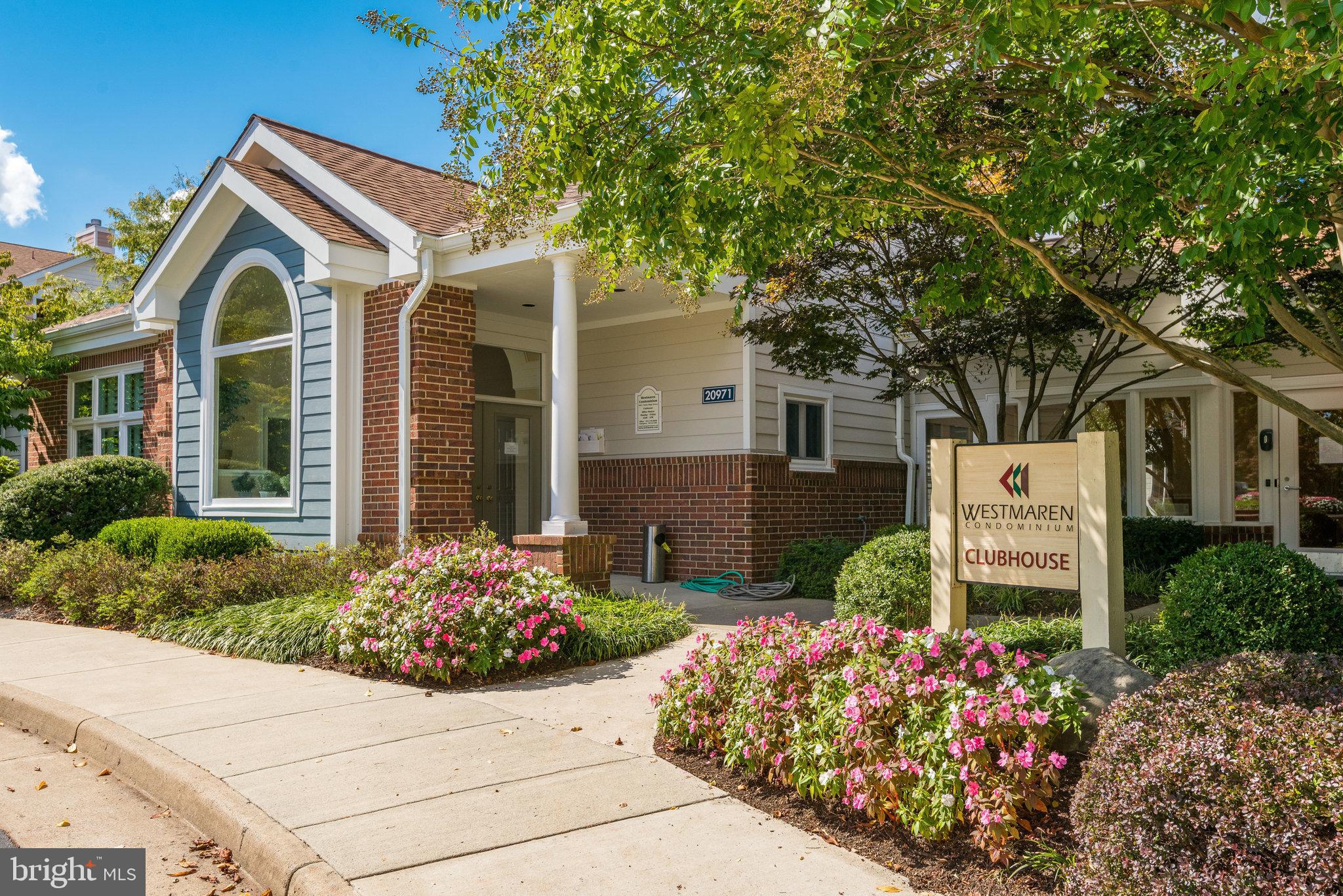20991 Timber Ridge Terrace, Unit 103 Ashburn, VA 20147 - Photo 39 of 58 a front view of a house with a garden