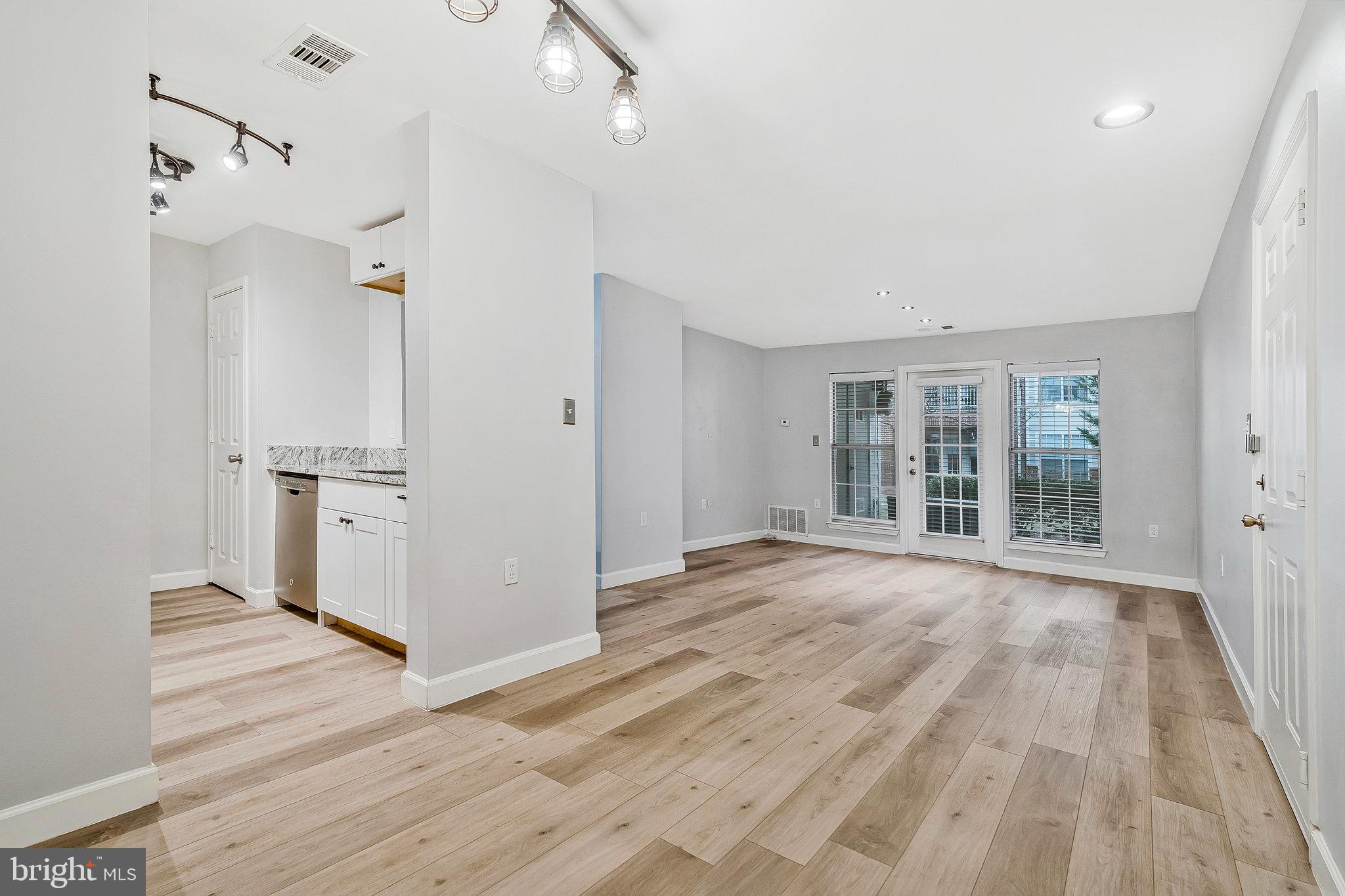 20991 Timber Ridge Terrace, Unit 103 Ashburn, VA 20147 - Photo 4 of 58 a view of a kitchen with wooden floor and a window