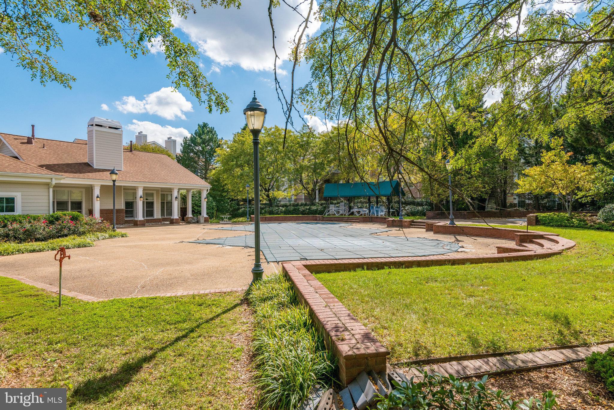 20991 Timber Ridge Terrace, Unit 103 Ashburn, VA 20147 - Photo 41 of 58 a view of a house with swimming pool