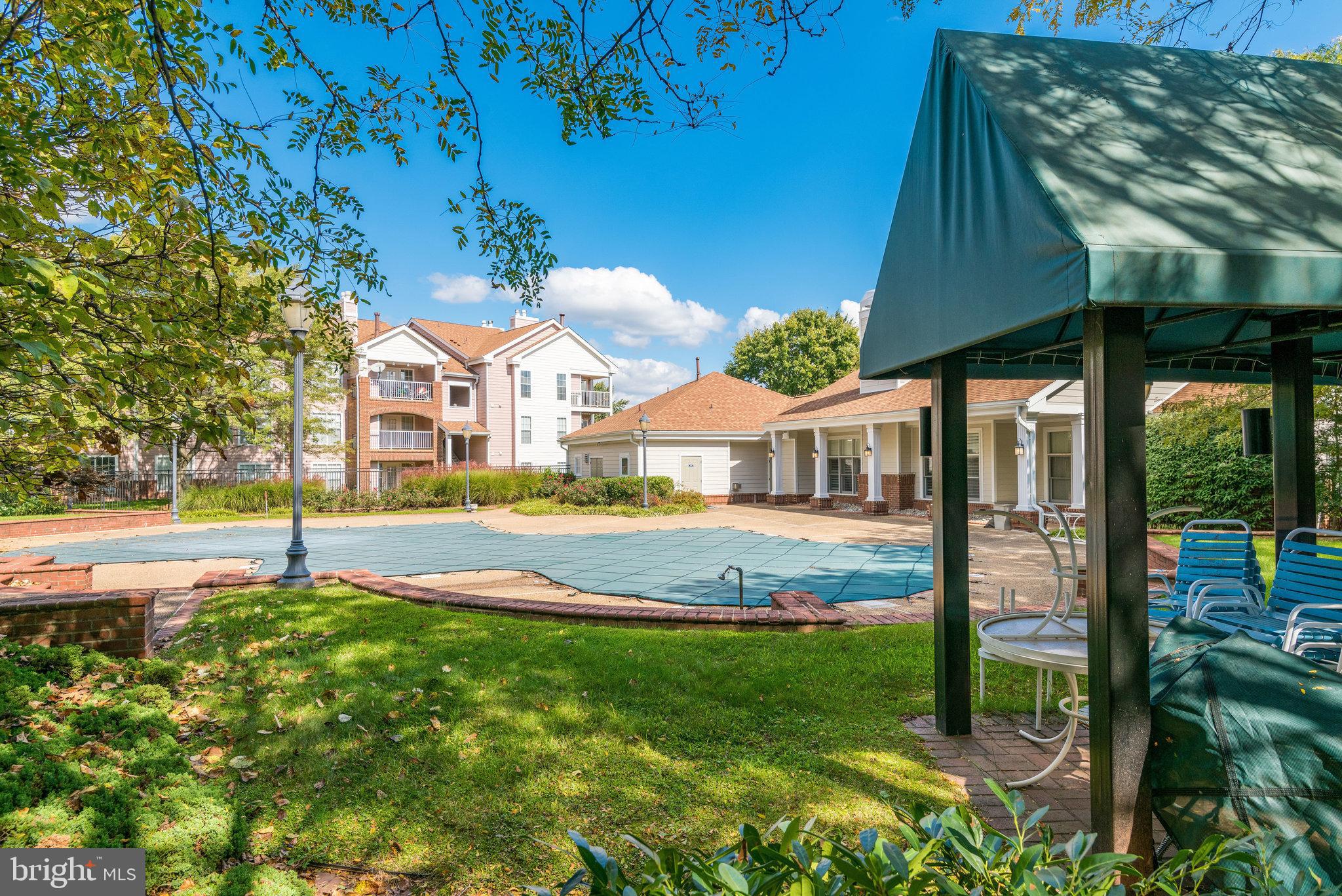 20991 Timber Ridge Terrace, Unit 103 Ashburn, VA 20147 - Photo 42 of 58 a view of an house with backyard and a tree