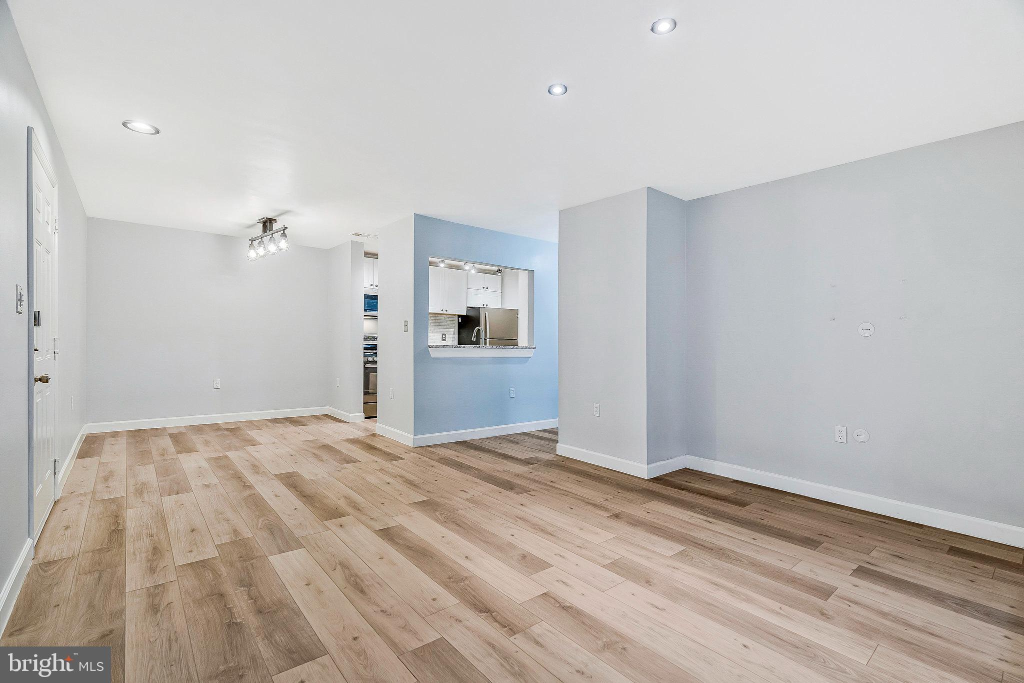 20991 Timber Ridge Terrace, Unit 103 Ashburn, VA 20147 - Photo 5 of 58 a view of empty room with wooden floor