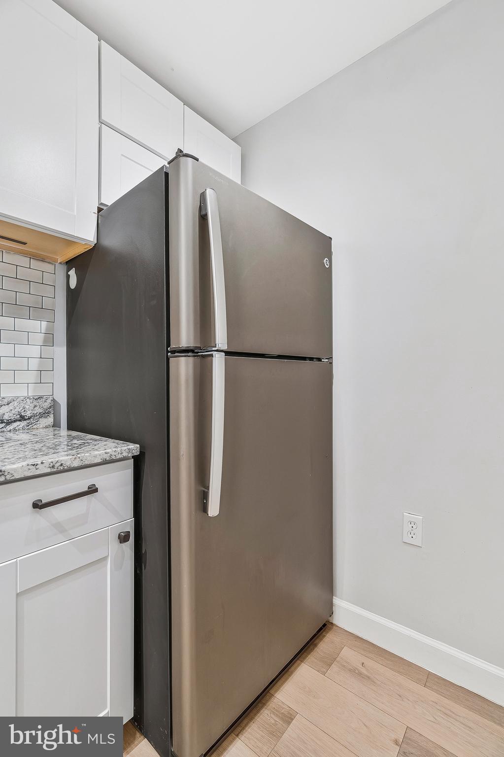 20991 Timber Ridge Terrace, Unit 103 Ashburn, VA 20147 - Photo 10 of 58 a white refrigerator freezer sitting inside of a kitchen