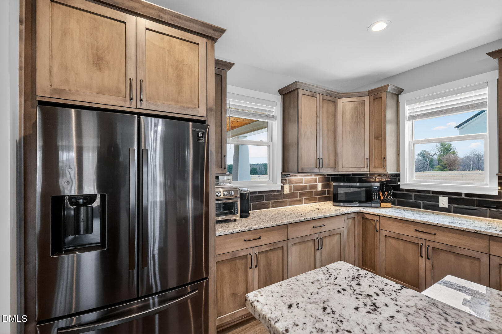540 Pine Ridge Road Zebulon, NC 27597 - Photo 21 of 96 a kitchen with stainless steel appliances a refrigerator sink and cabinets