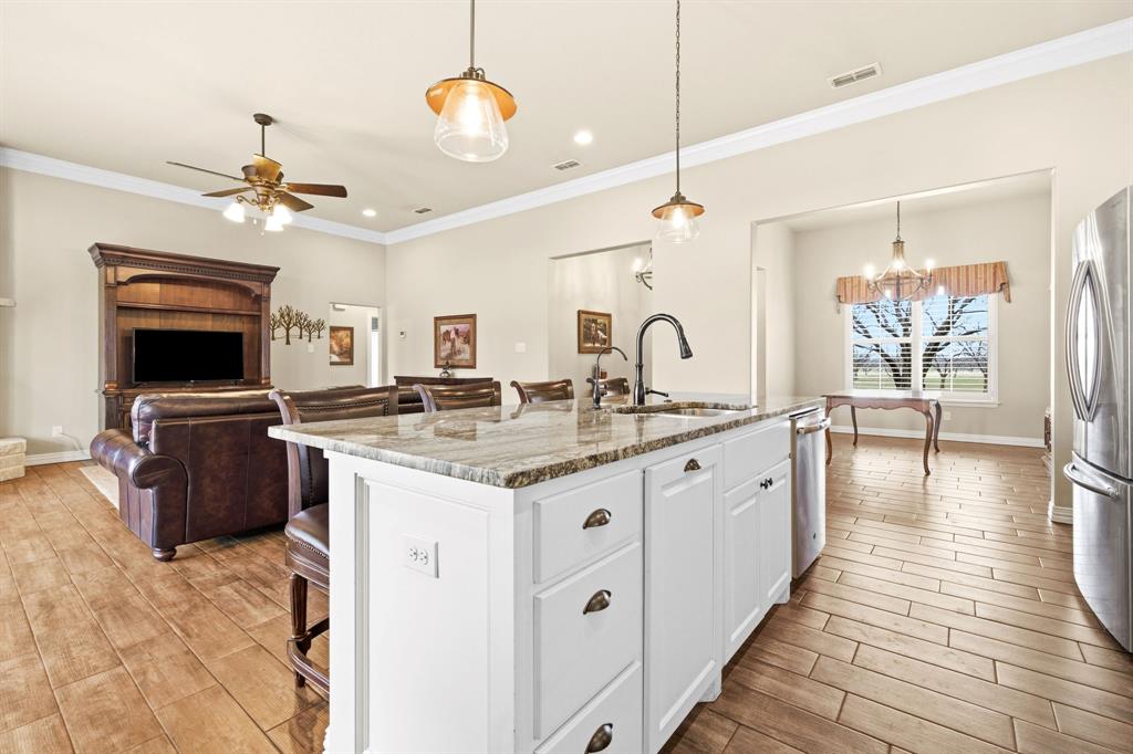 146 Mesquite Ridge Lane Lawn, TX 79530 - Photo 40 of 40 a kitchen with granite countertop a stove a sink and a refrigerator