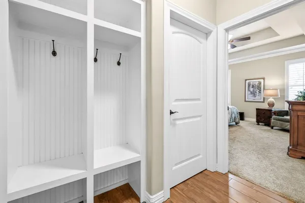 a kitchen with stainless steel appliances a dining table chairs stove and white cabinets