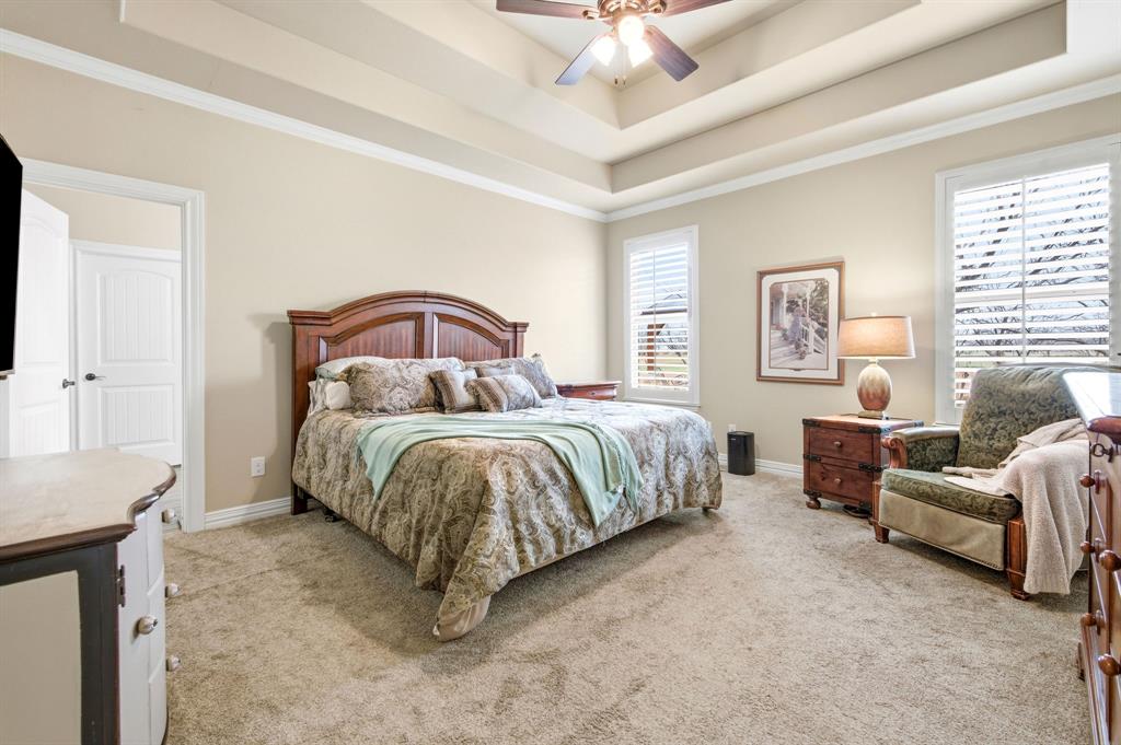146 Mesquite Ridge Lane Lawn, TX 79530 - Photo 16 of 40 a bedroom with a bed and a chandelier