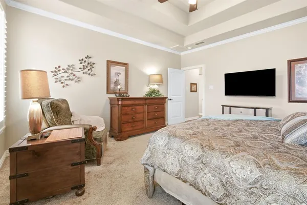 a bedroom with a bed and a chandelier