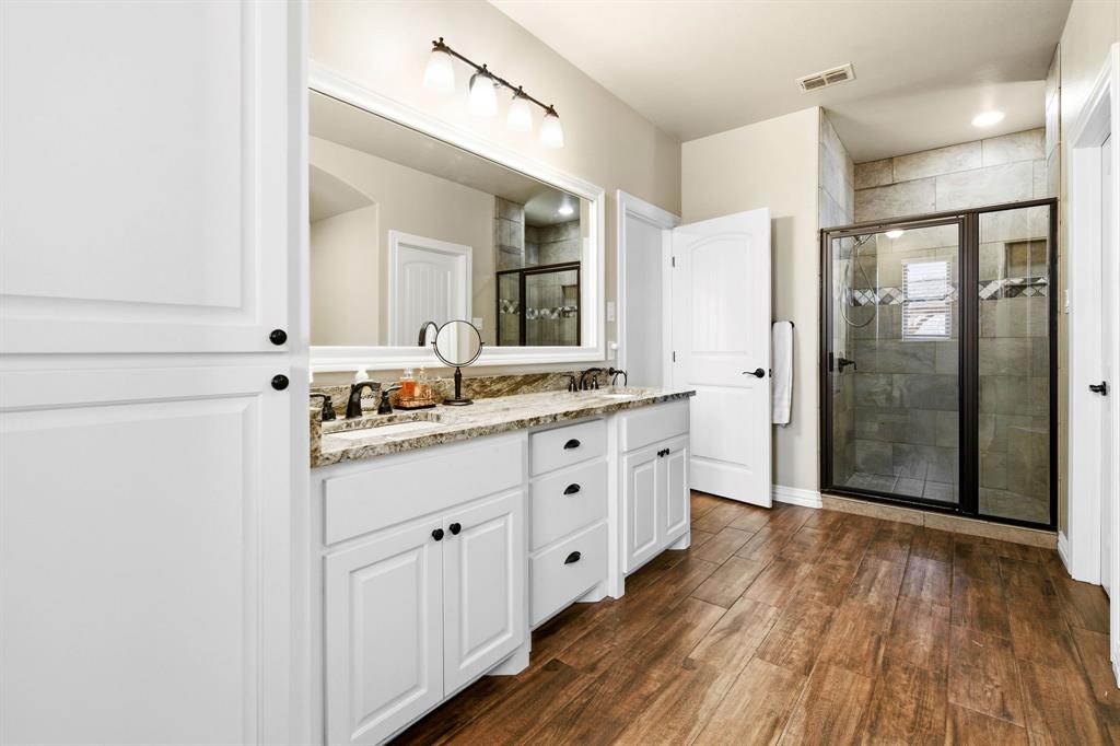 146 Mesquite Ridge Lane Lawn, TX 79530 - Photo 20 of 40 a spacious bathroom with a granite countertop sink mirror and shower