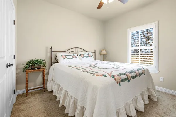 a bathroom with a tub a sink and glass door shower