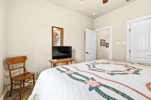 a spacious bathroom with a granite countertop sink mirror and shower