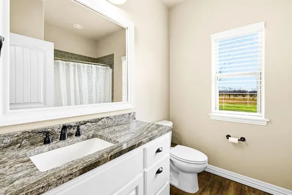 a bedroom with a bed and a potted plant