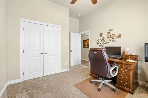 a bathroom with a granite countertop sink toilet and mirror