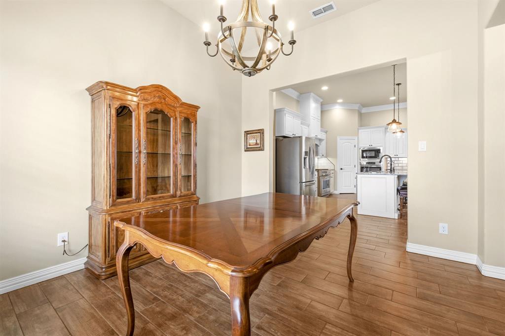 146 Mesquite Ridge Lane Lawn, TX 79530 - Photo 3 of 40 a view of a dining room with furniture and wooden floor