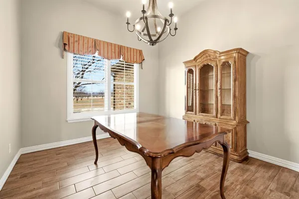a view of a room with furniture wooden floor and windows