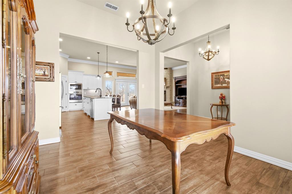 146 Mesquite Ridge Lane Lawn, TX 79530 - Photo 7 of 40 a view of a dining room with furniture and wooden floor