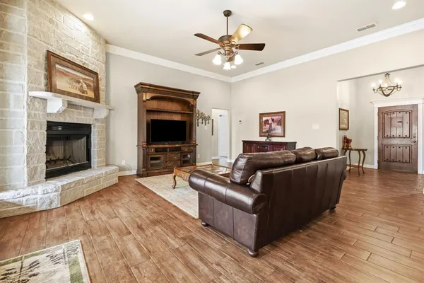 a living room with furniture a flat screen tv and a fireplace