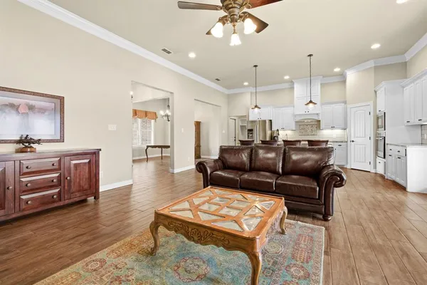 a living room with furniture and a wooden floor