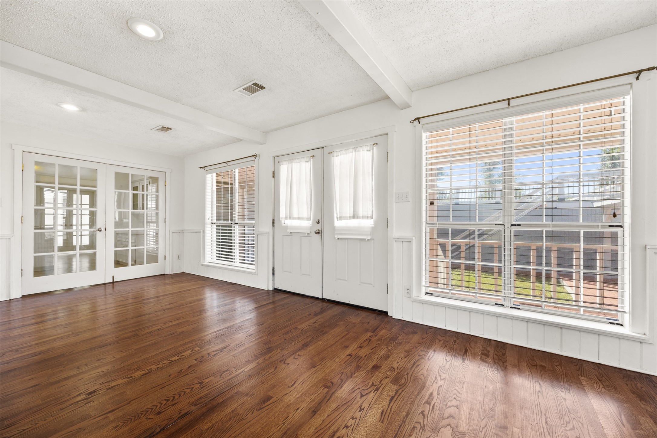 4910 Cark Street Santa Fe, TX 77517 - Photo 15 of 31 a view of an empty room with wooden floor and a window