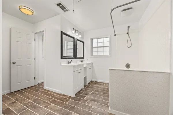 a bathroom with a sink a mirror and a shower