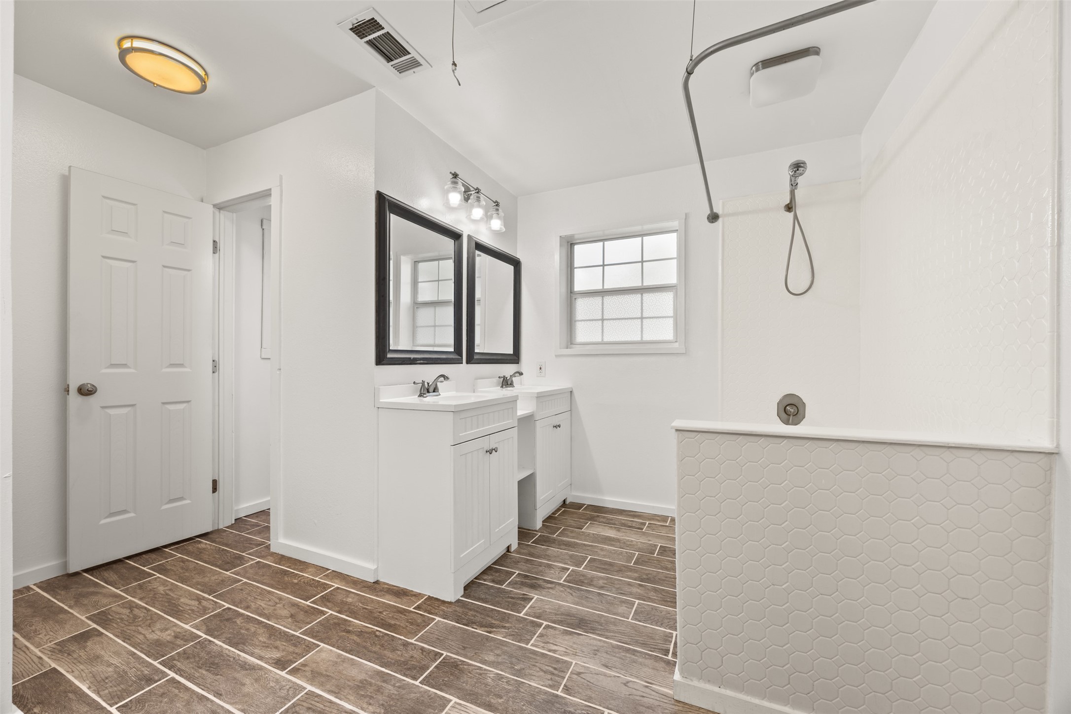 4910 Cark Street Santa Fe, TX 77517 - Photo 17 of 31 a bathroom with a sink a mirror and a shower