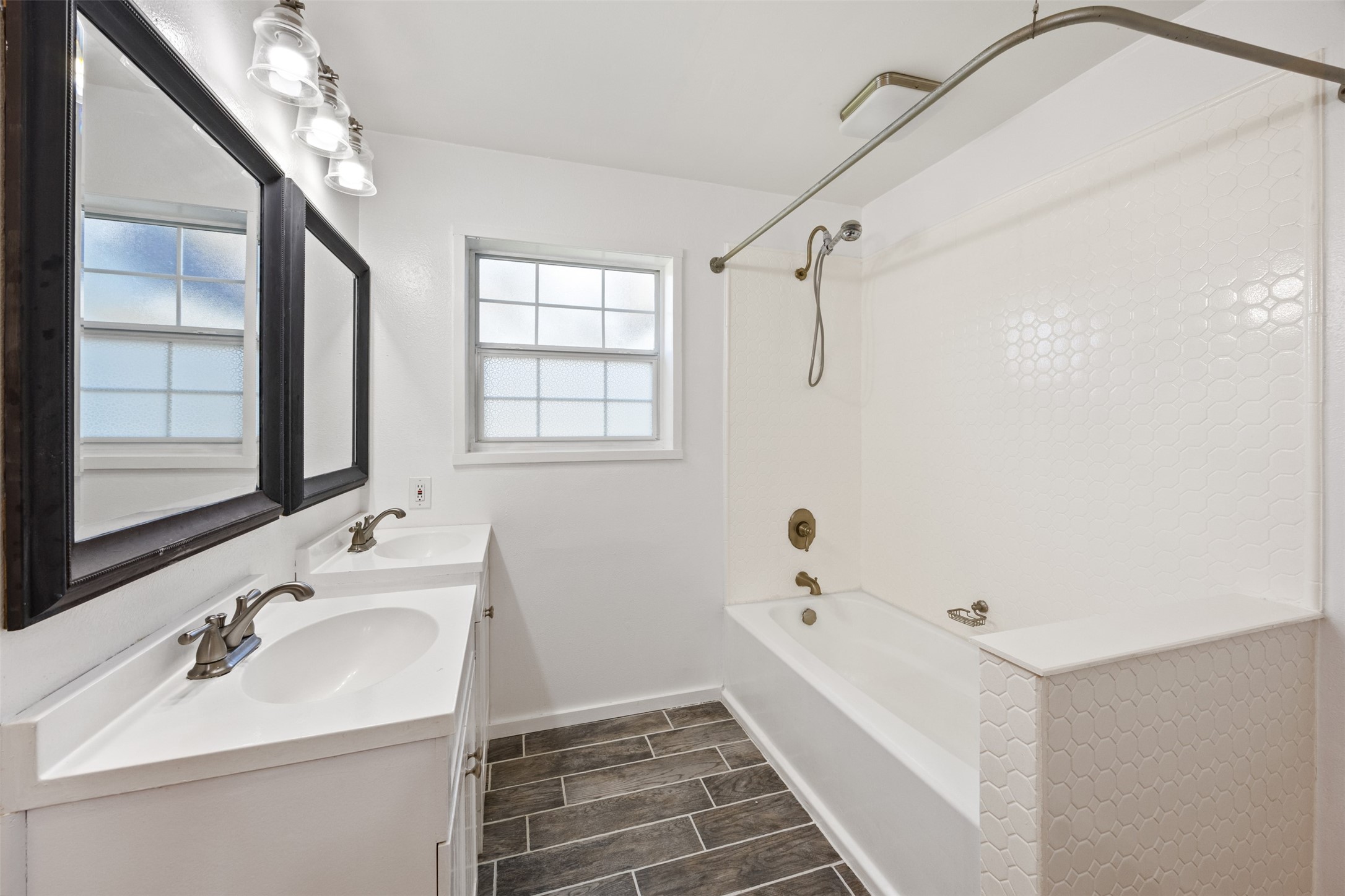 4910 Cark Street Santa Fe, TX 77517 - Photo 18 of 31 a bathroom with a sink a mirror and a shower