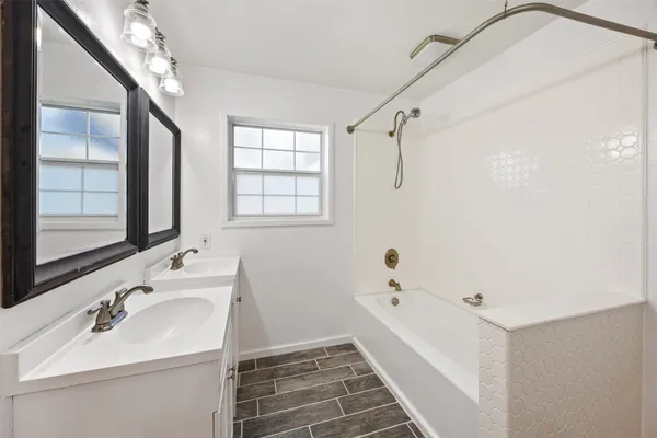 a bathroom with a sink a mirror and a shower