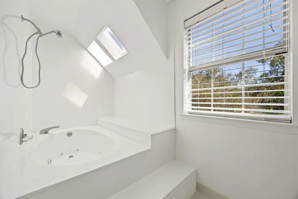 a bathroom with a bathtub and window