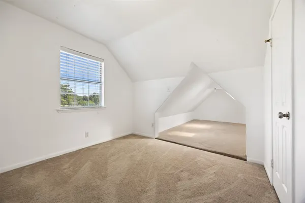 an empty room with a chandeliers fan